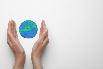 Woman and model of planet on white background, top view with space for text. Earth Day