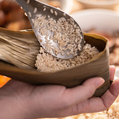 Making zongzi food - preparing and wrapping Chinese rice dumpling.