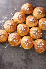 English bath buns roll with cumin and sugar close-up on the table. Vertical top view from above