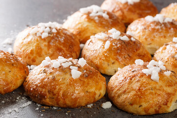 Delicious crispy hot bath bun with cumin and sugar close-up on the table. Horizontal