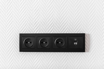 Obraz premium Electrical household switches and sockets close up. Minimalist interior design. Stylish bedroom and living room- Image