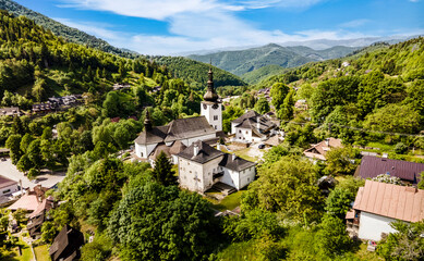 Church in The Spania Dolina village with mining landscape, Slovakia, Europe.
