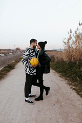 Couple Looking each other and touching her noses with a yellow basketball in countryside