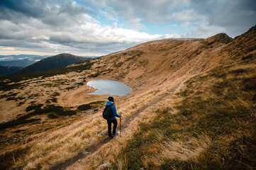 Sporty woman walking with nordic canes on high mountains