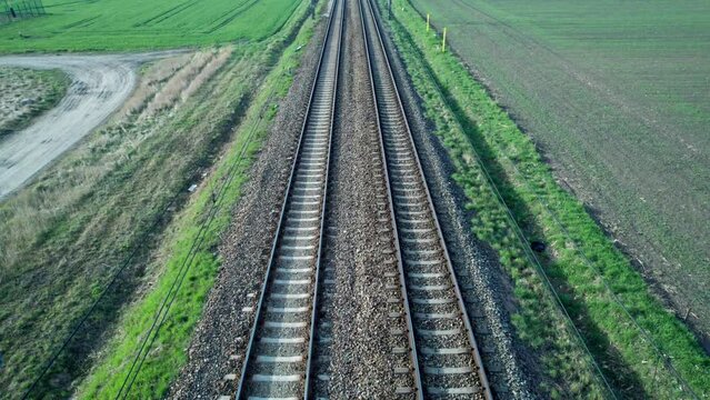 The railroad tracks seen from above, above the traction line.