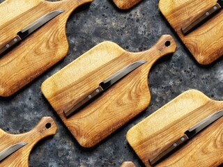 Pattern of rustic knife on wooden cutting board on black concrete background. Kitchen design...