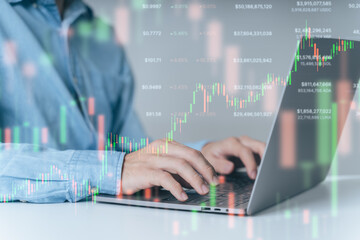 Trader, investor, businessman using laptop for trading, investing with technical trading price chart background. Trader trading, investing on stock market, Bitcoin Cryptocurrency on online platform.