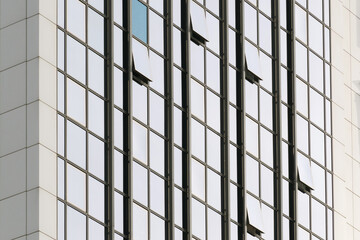 Geometric colored building facade elements with planes, lines and corners with light flare and reflections for an abstract background and texture of white, blue, gray colors. Place for text