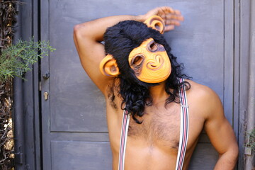 Shirtless man wearing gorilla mask