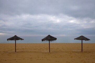 Tropical sun umbrellas on the Algarve coast - Portugal 