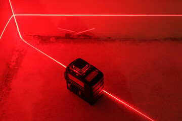 Red Laser level turned on in a dark room