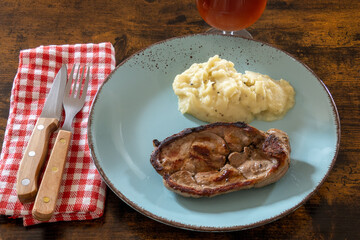 top view of a slice of lamb with mashed potatoes on a plate