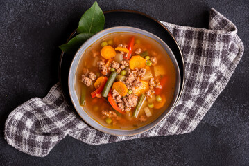 Vegetable soup on dark background, hot healthy food