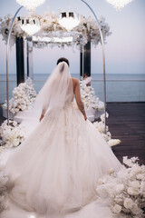 bride walks down the aisle at the wedding ceremony