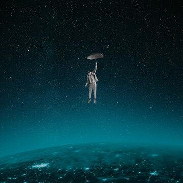 Contemporary art collage. Young man falling down with umbrella on space land. Conceptual image