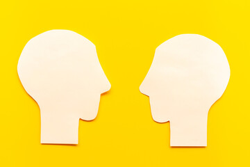 Social communication and connection concept with two paper human heads