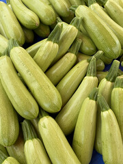 Green zucchini on the counter in the store. Close-up