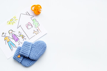 Childrens pencil drawing of family with booties. Adoption concept. Top view
