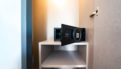 Opened Unlock digital modern Black Safe box, Stroungbox on the shelf in wood Closet in Hotel room - obrazy, fototapety, plakaty