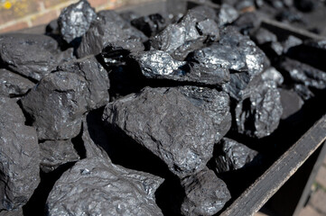 Old-fashioned, non-environmental heating fuel, black rock coal for use in stoking area, air pollution