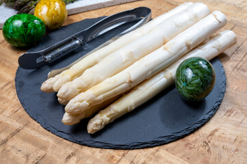 Cooking of fresh white asparagus vegetables, peeler knife for asparagus