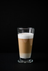 Coffee with milk on dark background. Close up. Copy space. 