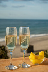 Outdoor breakfast with Spanish cava sparkling wine and pineapple with view on blue sea and sandy beach in Marbella, Costa del Sol vacation destination, Andalusia, Spain