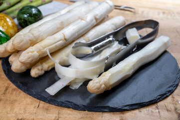 Fototapeta na wymiar Cooking of fresh white asparagus vegetables, peeler knife for asparagus