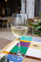 Glass of Spanish dry white wine served on outdoor terrace in Granada, Spain
