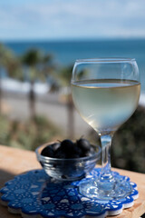 Spanish dry rueda white wine and black olives tapas served on beach terrace with view on Mediterranean sea