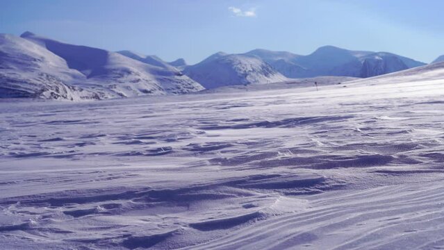 Spindrift over the snow covered mountains in Swedish Lapland.