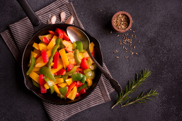 Cooked bell peppers of different colors, healthy vegetable dish