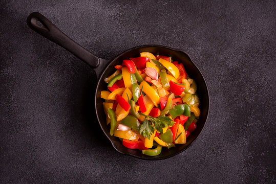 Cooked bell peppers of different colors, healthy vegetable dish