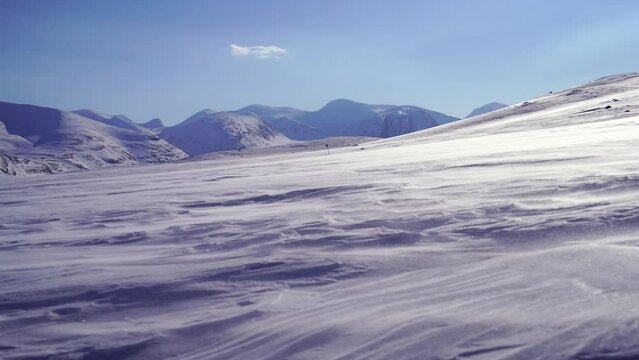 Spindrift over the snow covered mountains in Swedish Lapland.