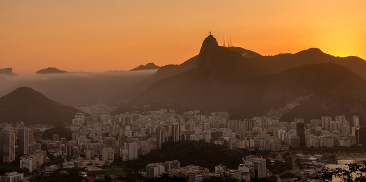 Amazing sunset over the city, seen from Sugar Loaf, with the statue of the Christ Redeemer on the horizon. Rio de Janeiro, RJ, Brazil.