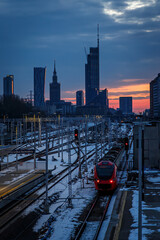 Public transportation in Warsaw, Poland. City skyline and railroad station.