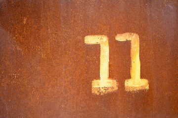 On the rusty surface in paint is written 11