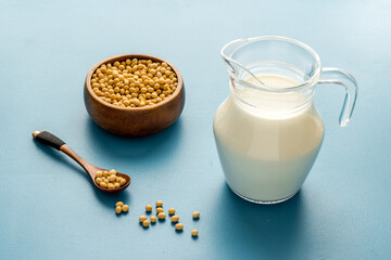 Non dairy vegan milk in glass jar with ingredients, close up