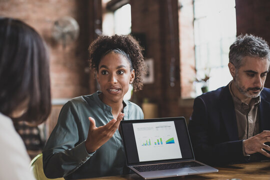 African American businesswoman leading a meeting using a digital tablet presentation