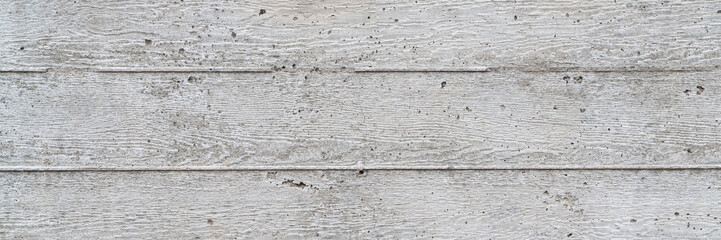 Fototapeta na wymiar texture of new gray grunge concrete wall with embedded grain and pattern of wooden planks for background, panoramic web banner
