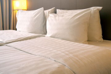 Interior of a room in Hotel with white pillows and and bed linen