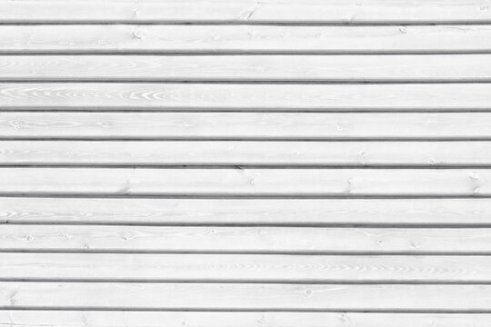 White wooden board exterior wall texture. Old knotty whitewashed wood planks. Abstract light rustic vintage background