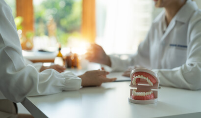 dentist and patient discussion about planned teeth treatment in dental clinic office - dentist consultation concept
