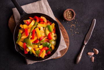 Cooked bell peppers of different colors, healthy vegetable dish