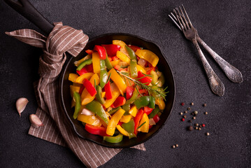 Cooked bell peppers of different colors, healthy vegetable dish