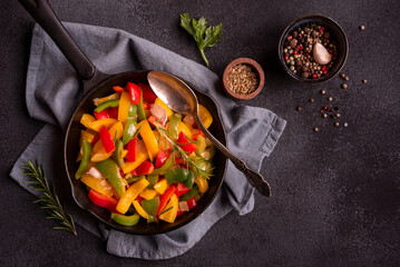Cooked bell peppers of different colors, healthy vegetable dish