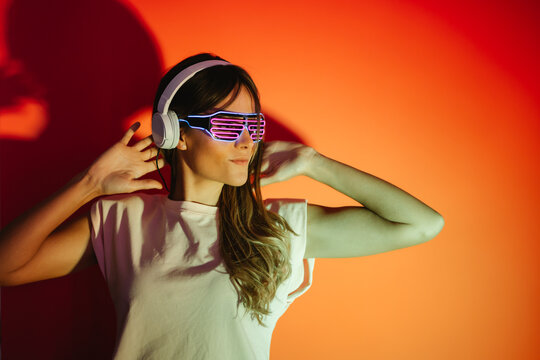 Woman in sunglasses listening to music