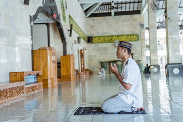 portrait of asian Man muslim doing prayer in the mosque