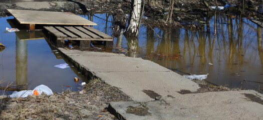 Improvised makeshift bridge over a ditch with water