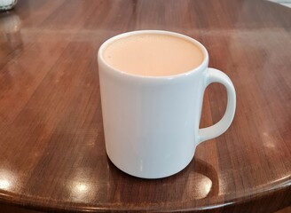Raf coffee drink in a cup and on the table